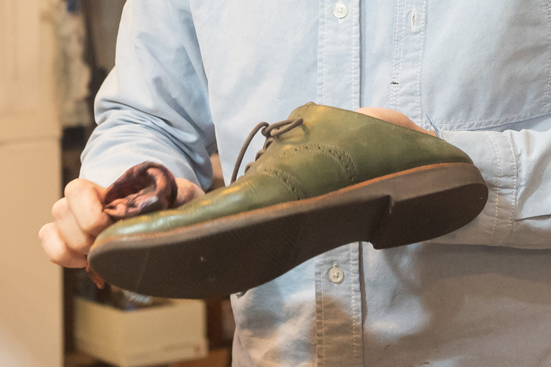職人がお客様の靴を丁寧に磨き上げている様子
